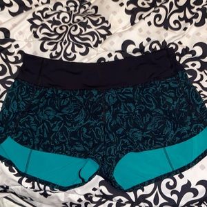 lululemon shorts. dark blue ish green and black